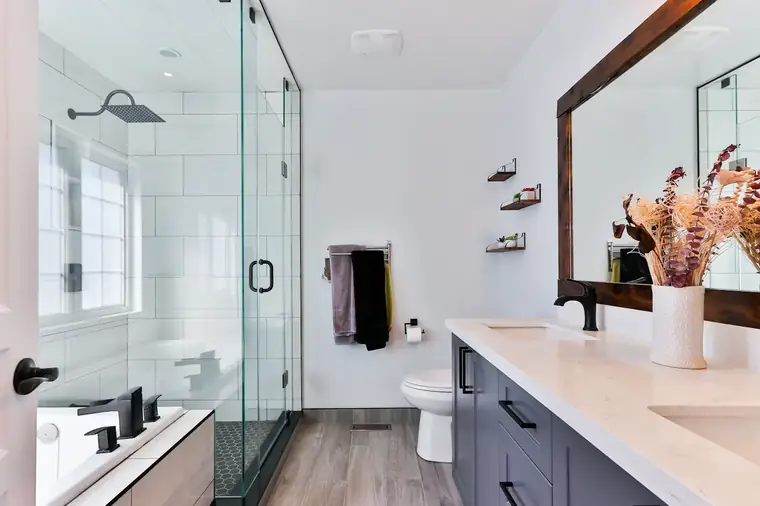 Bathroom remodeling project with new tile and glass shower finishes